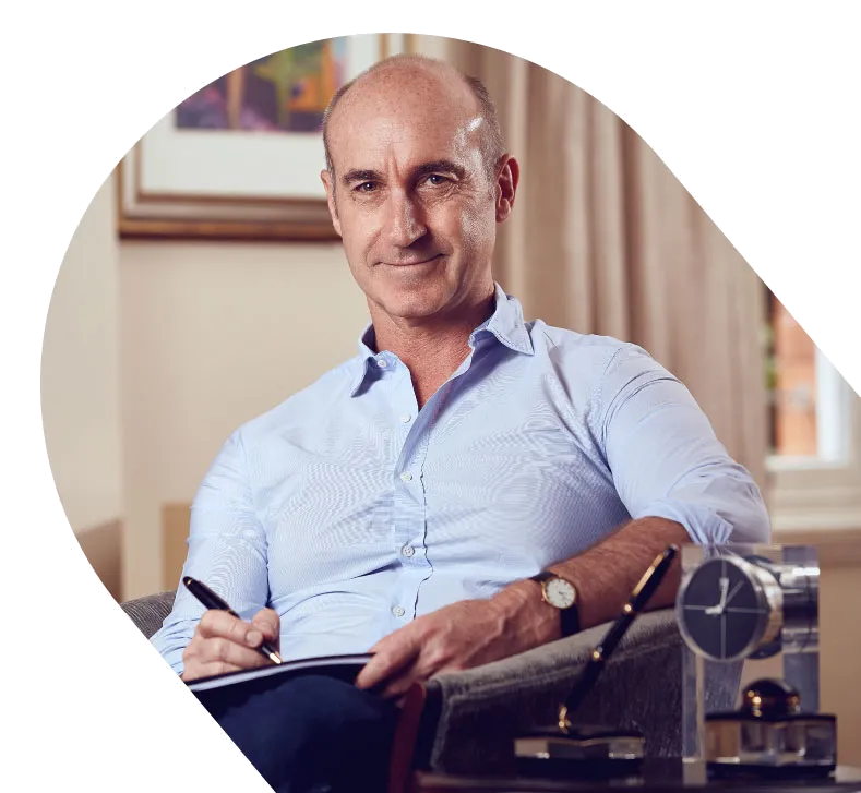 Francois de Marigny seated with a notebook in his consulting rooms, Morningside, Durban